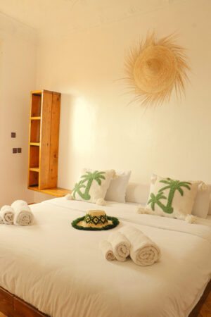 cactus pillows on the double bed in room with private balcony