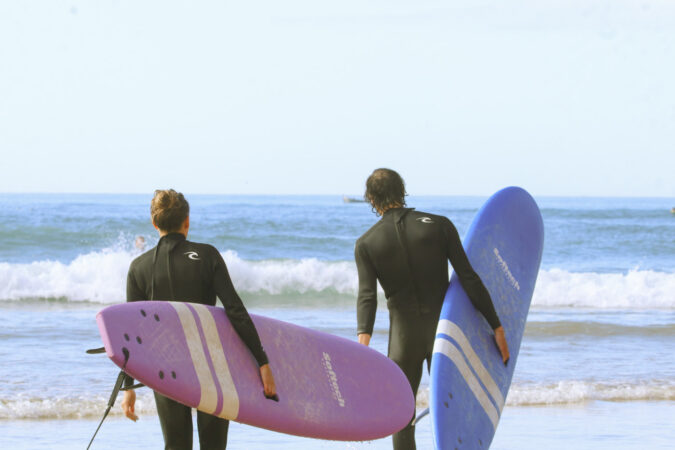 Couple surfing with foam boards in The Bay, Imsouane